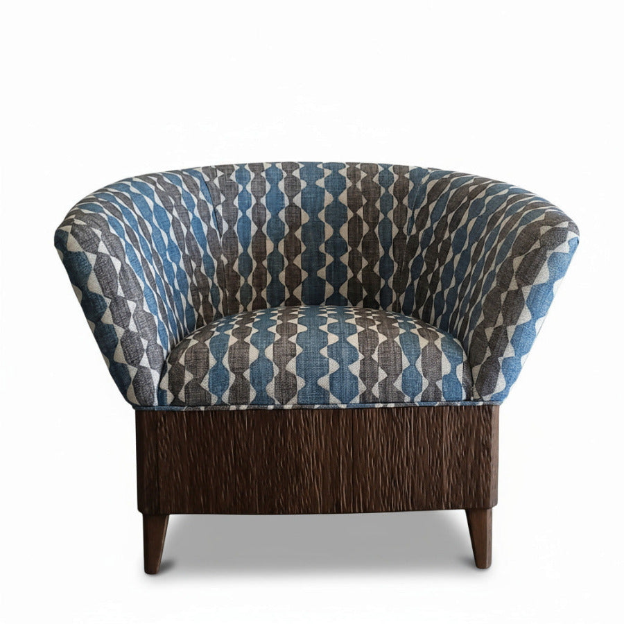 Patterned armchair with wooden base against a white background.